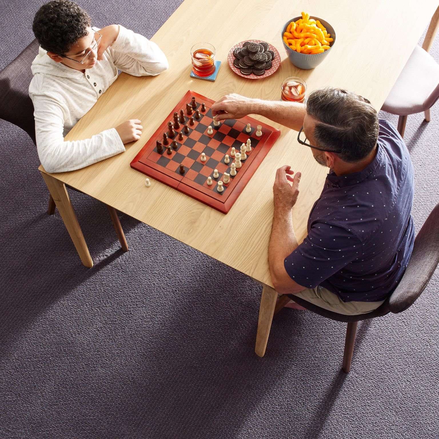 People playing chess in carpeted room