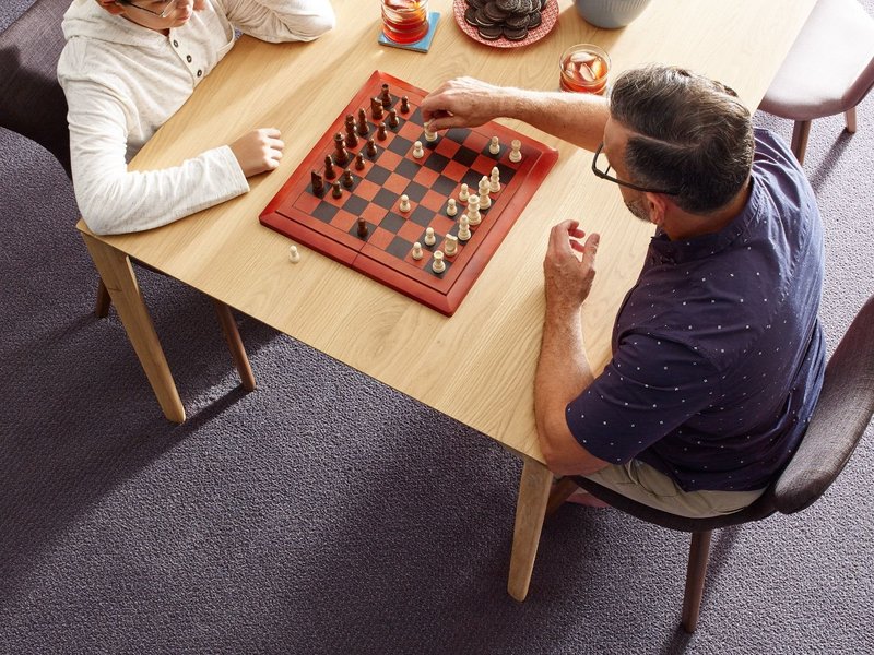 People playing chess in carpeted room